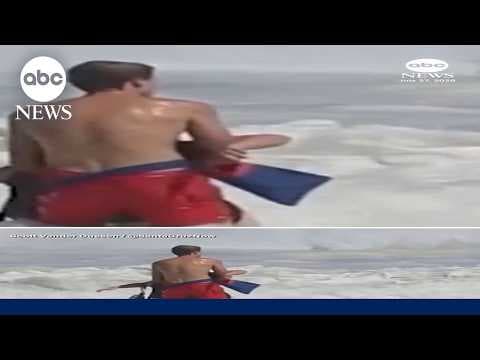 Lifeguard battles high surf to rescue swimmer